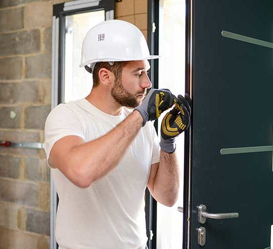 Worker Installing A door